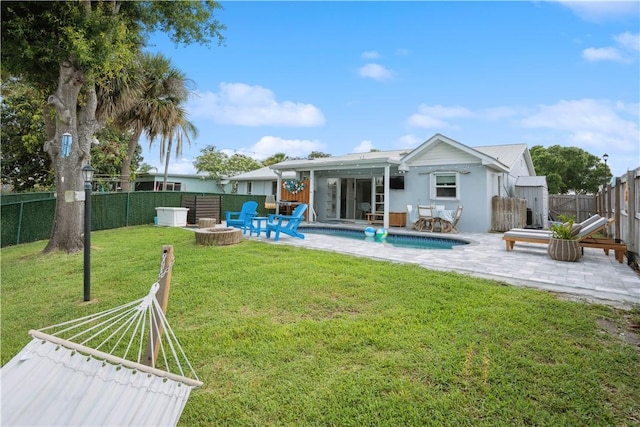1933 Robalo Dr, Vero Beach, FL 32960 - rear view of house with a patio, a fenced backyard, a fire pit, and stucco siding