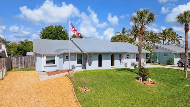1933 Robalo Dr, Vero Beach, FL 32960 - ranch-style home with driveway, a metal roof, and stucco siding