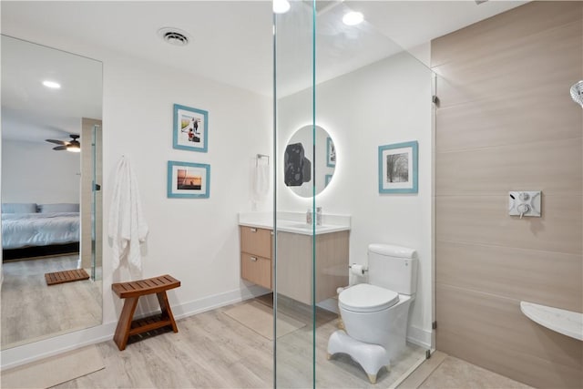 1933 Robalo Dr, Vero Beach, FL 32960 - full bathroom with vanity, wood finished floors, a ceiling fan, and connected bathroom