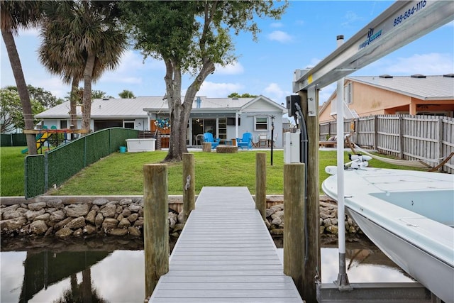1933 Robalo Dr, Vero Beach, FL 32960 - dock area featuring a fenced backyard and a water view