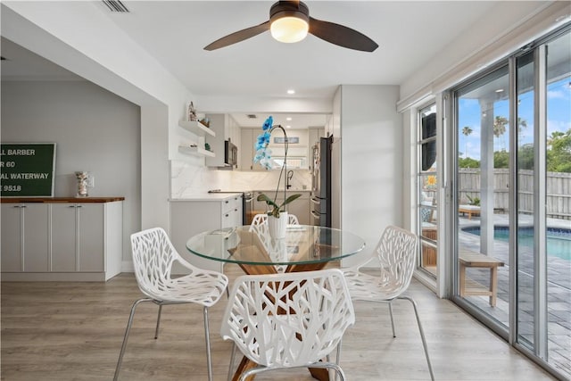 1933 Robalo Dr, Vero Beach, FL 32960 - dining room with light wood finished floors, ceiling fan, and recessed lighting