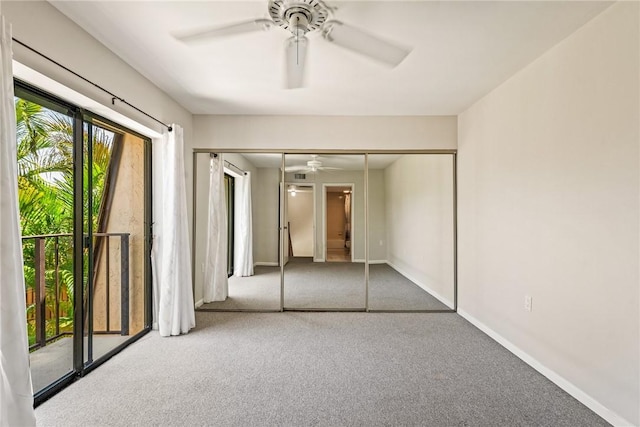 415 E Waverly Pl Unit 1C, Vero Beach, FL 32960 - unfurnished bedroom featuring baseboards, a ceiling fan, carpet flooring, and a closet