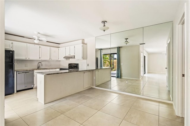 415 E Waverly Pl Unit 1C, Vero Beach, FL 32960 - kitchen with dark stone counters, tasteful backsplash, black appliances, under cabinet range hood, and light tile patterned floors