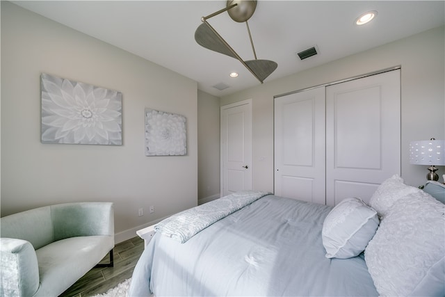 bedroom with parquet flooring, a closet, and ceiling fan