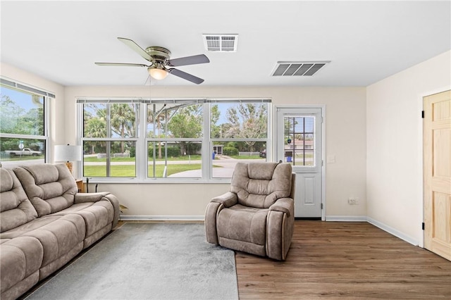 2106 36th Ave, Vero Beach, FL 32960 - living area with plenty of natural light, a ceiling fan, and wood finished floors