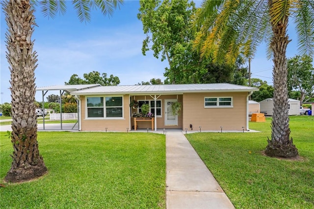 2106 36th Ave, Vero Beach, FL 32960 - view of front of house featuring a front lawn and a metal roof