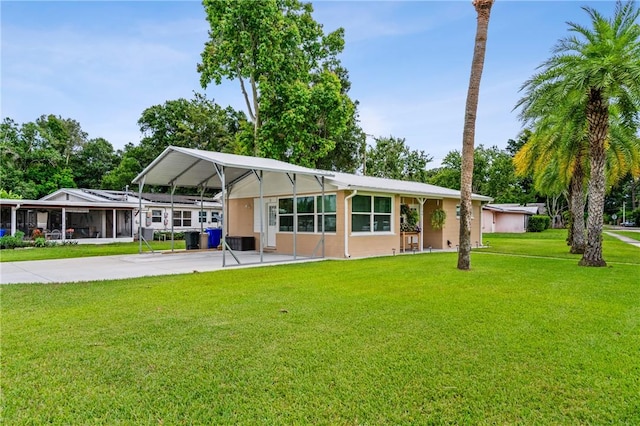2106 36th Ave, Vero Beach, FL 32960 - view of front of property featuring concrete driveway, a front lawn, and a carport
