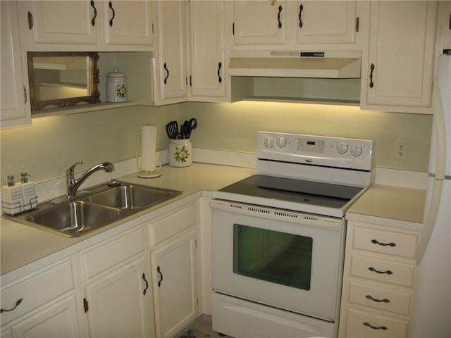 kitchen featuring sink, white appliances, white cabinetry, and range hood