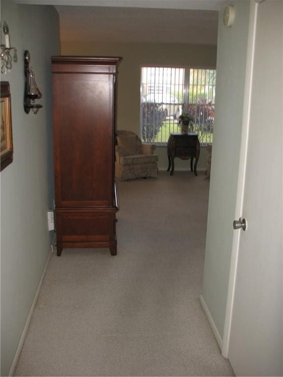 hallway with light colored carpet