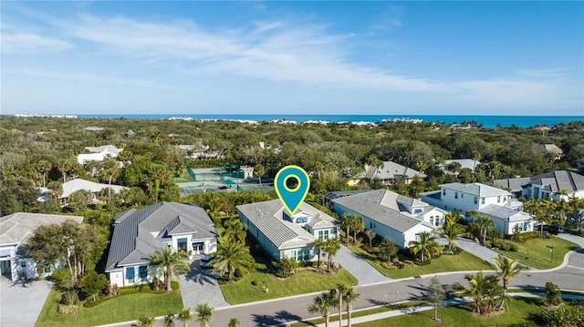 birds eye view of property with a water view