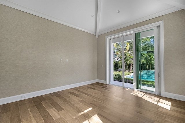 interior space with ornamental molding, light hardwood / wood-style floors, and vaulted ceiling