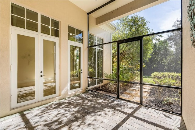 unfurnished sunroom with plenty of natural light and french doors