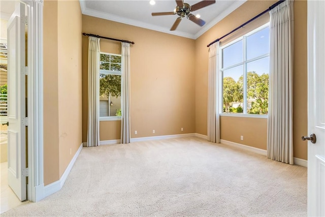 carpeted empty room with baseboards, ceiling fan, and ornamental molding