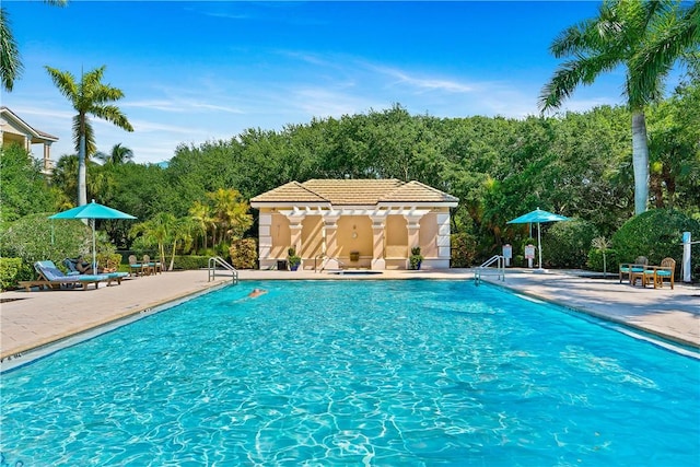 community pool featuring a patio and fence