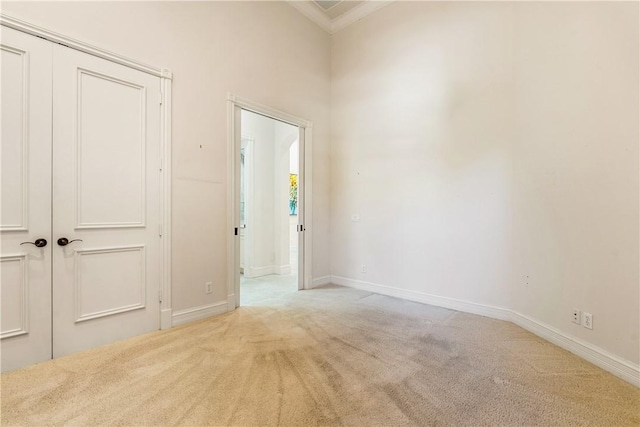 empty room with baseboards, ornamental molding, and carpet flooring