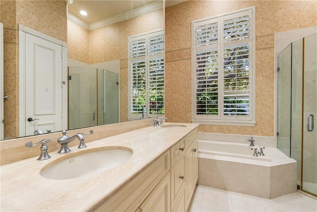 bathroom featuring wallpapered walls, a bath, a stall shower, and a sink