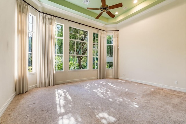 carpeted empty room featuring visible vents, baseboards, ceiling fan, a tray ceiling, and recessed lighting