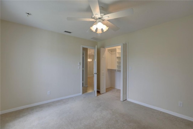 unfurnished bedroom featuring a ceiling fan, a closet, visible vents, baseboards, and light carpet