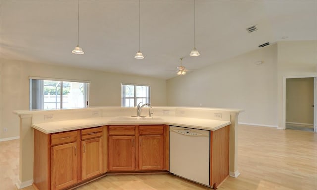 kitchen with a sink, light wood finished floors, open floor plan, and dishwasher