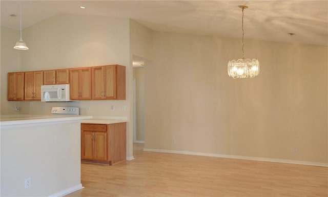 kitchen with stove, an inviting chandelier, white microwave, high vaulted ceiling, and light wood-type flooring