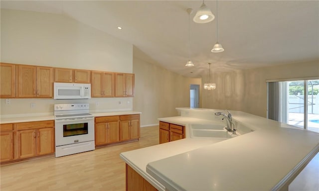 kitchen with white appliances, light wood finished floors, a sink, a large island, and light countertops