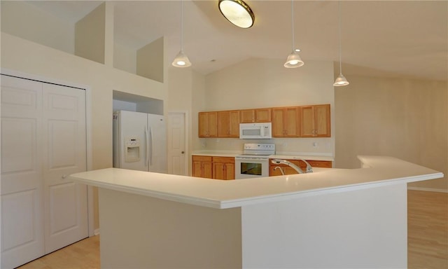 kitchen featuring light wood finished floors, light countertops, high vaulted ceiling, and white appliances