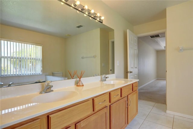 bathroom with toilet, visible vents, and a sink