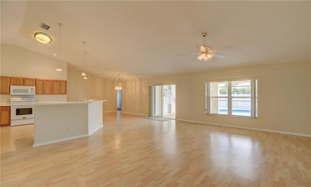 unfurnished living room with vaulted ceiling, visible vents, light wood finished floors, and ceiling fan with notable chandelier