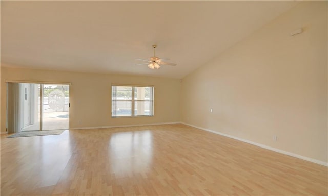 empty room with plenty of natural light, light wood-style flooring, baseboards, and ceiling fan