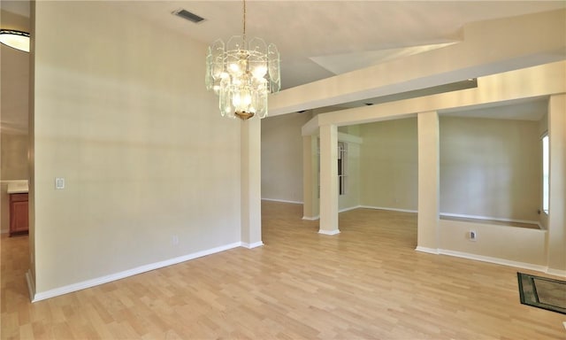 unfurnished dining area with light wood finished floors, visible vents, and an inviting chandelier