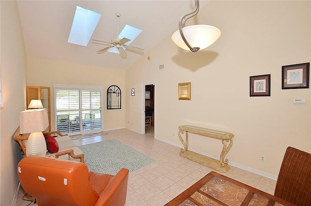 tiled living room featuring ceiling fan, high vaulted ceiling, and a skylight