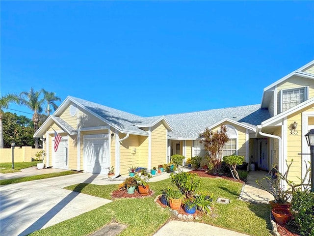 view of front of house with a front yard and a garage