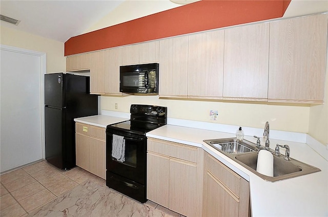 kitchen featuring black appliances, sink, light brown cabinetry, and vaulted ceiling