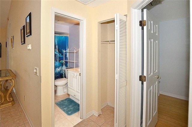 corridor with light tile patterned floors