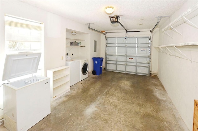 garage featuring separate washer and dryer, electric panel, and a garage door opener