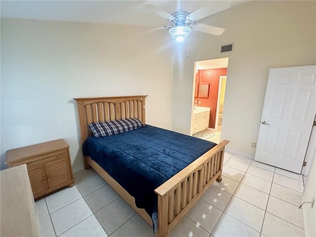 tiled bedroom with ensuite bath, ceiling fan, and vaulted ceiling