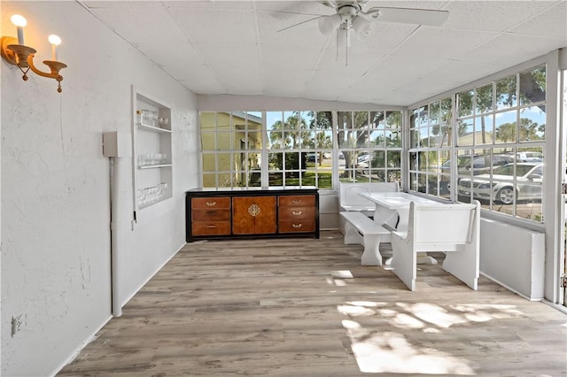 unfurnished sunroom with wood finished floors