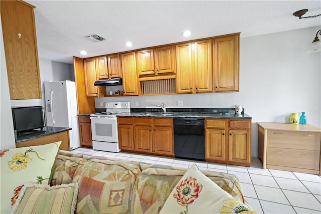 kitchen with visible vents, dark countertops, white appliances, under cabinet range hood, and a sink
