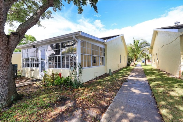 view of side of home featuring stucco siding