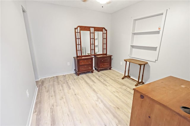 interior space with baseboards and light wood finished floors