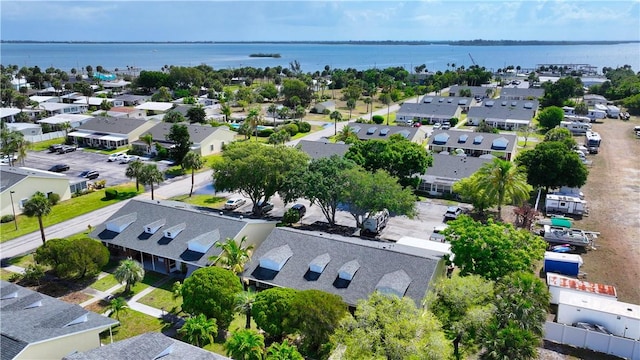 drone / aerial view with a residential view and a water view