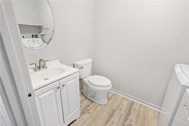 bathroom featuring vanity, toilet, and wood finished floors