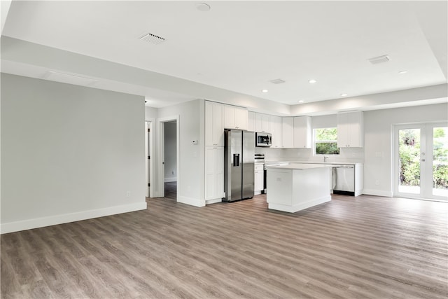 kitchen featuring white cabinetry, a center island, light hardwood / wood-style floors, and appliances with stainless steel finishes