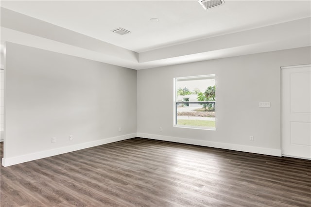 spare room with dark hardwood / wood-style flooring