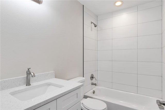 full bathroom featuring vanity, toilet, and tiled shower / bath combo