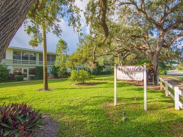 view of property's community with a lawn