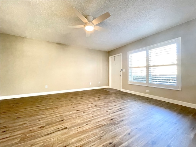 empty room featuring hardwood / wood-style floors, ceiling fan, and a textured ceiling