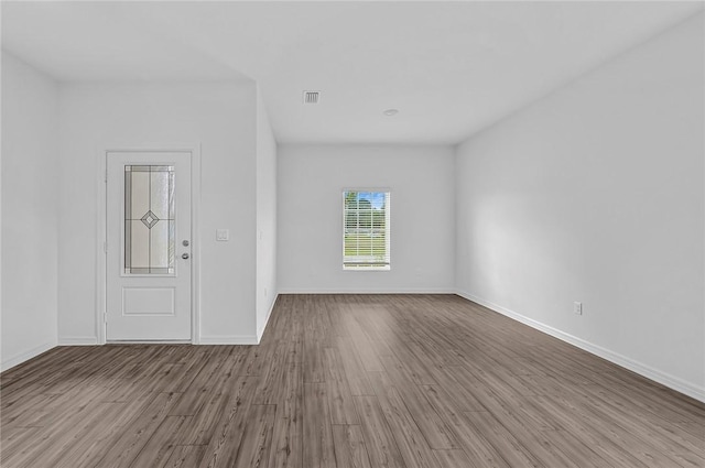 8415 98th Ct, Vero Beach, FL 32967 - unfurnished room with wood finished floors and baseboards