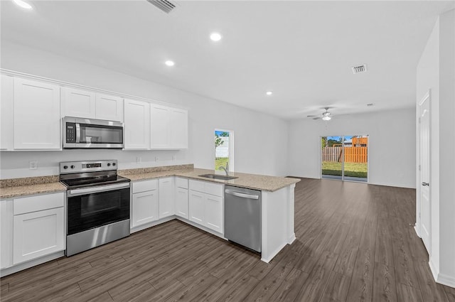 8415 98th Ct, Vero Beach, FL 32967 - kitchen featuring appliances with stainless steel finishes, open floor plan, ceiling fan, white cabinets, and a peninsula