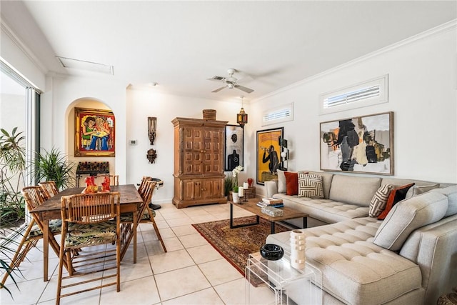 living room featuring light tile patterned floors, ceiling fan, and crown molding